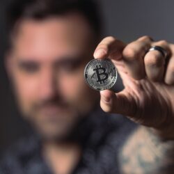 Person Holding Silver Bitcoin Coin
